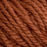 Close-up of Halcyon Yarn Classic Rug Wool | Skein by Caledonian Dye Works, showcasing its soft, brown yarn with visible twisted fibers. The texture appears thick, slightly fluffy, and suitable for knitting or crocheting projects. Ideal for weavers aiming to create hand-dye masterpieces or use as Rug Wool for robust designs.