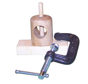 The Acorn Holding Fixture for Viking Style Combs by Sunrise Metal Works is a wooden mechanical toy featuring movable maple parts mounted on a base. It comes with a heavy-duty metal C-clamp for adjustments and includes a vertical wooden peg that rotates within a cylindrical wooden housing with a rectangular opening.