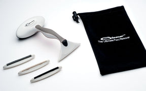 An image of the Gleener De-pilling & De-fuzzing Kit, the ultimate fabric revitalizer. It includes an ergonomic handle with a shaver head attached, three interchangeable fabric-safe edges, and a black drawstring storage bag with the logo "Gleener The Ultimate Fuzz Remover".