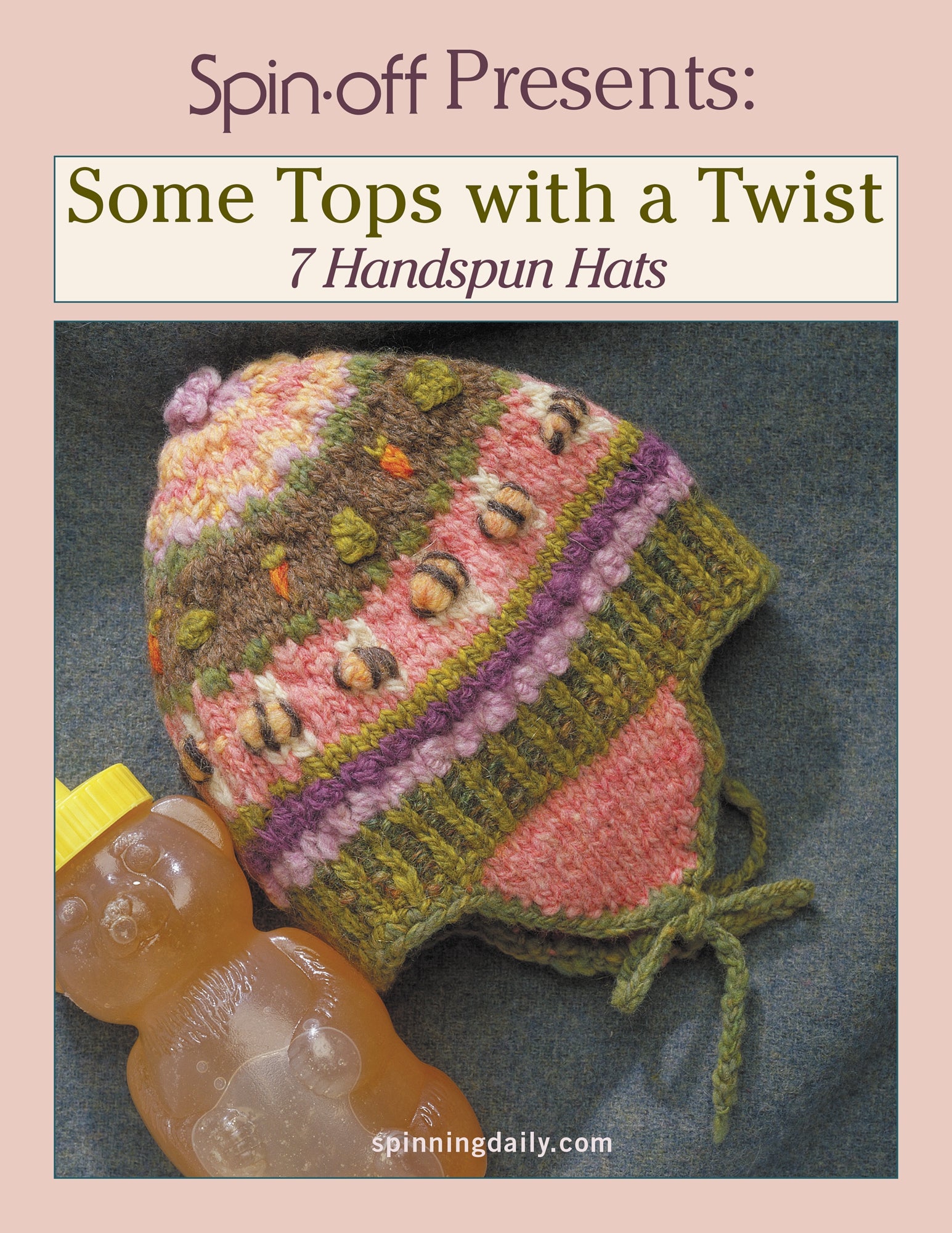 Cover of "Spin-Off Presents: Some Tops with a Twist: 7 Handspun Hats: eBook Printed Copy" by Long Thread Media featuring a colorful, knitted hat with a floral pattern next to a honey bear bottle, all set against a dark fabric background. The website "spinningdaily.com" is listed at the bottom.