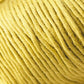 Close-up image of a spool of Jo Sharp Soho Summer DK Cotton yarn by Kingfisher Yarn & Fibre. The yarn strands are tightly wound together, with a smooth surface texture and a consistent, rich yellow color. The lighting highlights the tactile detail of this summer yarn, perfect for lightweight cotton projects.