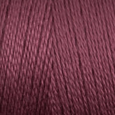 Close-up of a mini cone of Maurice Brassard 8/2 Tencel yarn in a rich mauve color, showcasing the twisted strands and texture. The yarn appears smooth and tightly wound, with a consistent and even color throughout. Perfect for knitting accessories, the image highlights the details of the fibers and their sheen.