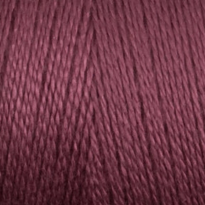 Close-up of a mini cone of Maurice Brassard 8/2 Tencel yarn in a rich mauve color, showcasing the twisted strands and texture. The yarn appears smooth and tightly wound, with a consistent and even color throughout. Perfect for knitting accessories, the image highlights the details of the fibers and their sheen.