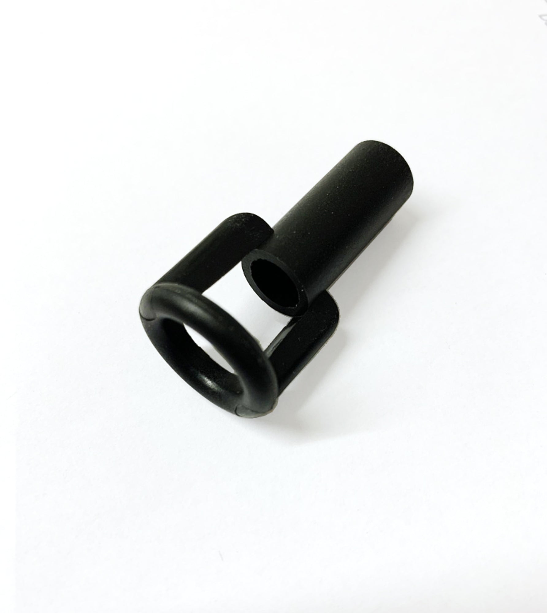 A Louët Scotch Tension Orifice, a small black cylindrical plastic part featuring a hollow center and two supporting arms, rests against a white background. This component from Louët Inc. has a straightforward mechanical design, suggesting it functions as specialized hardware or a connector.