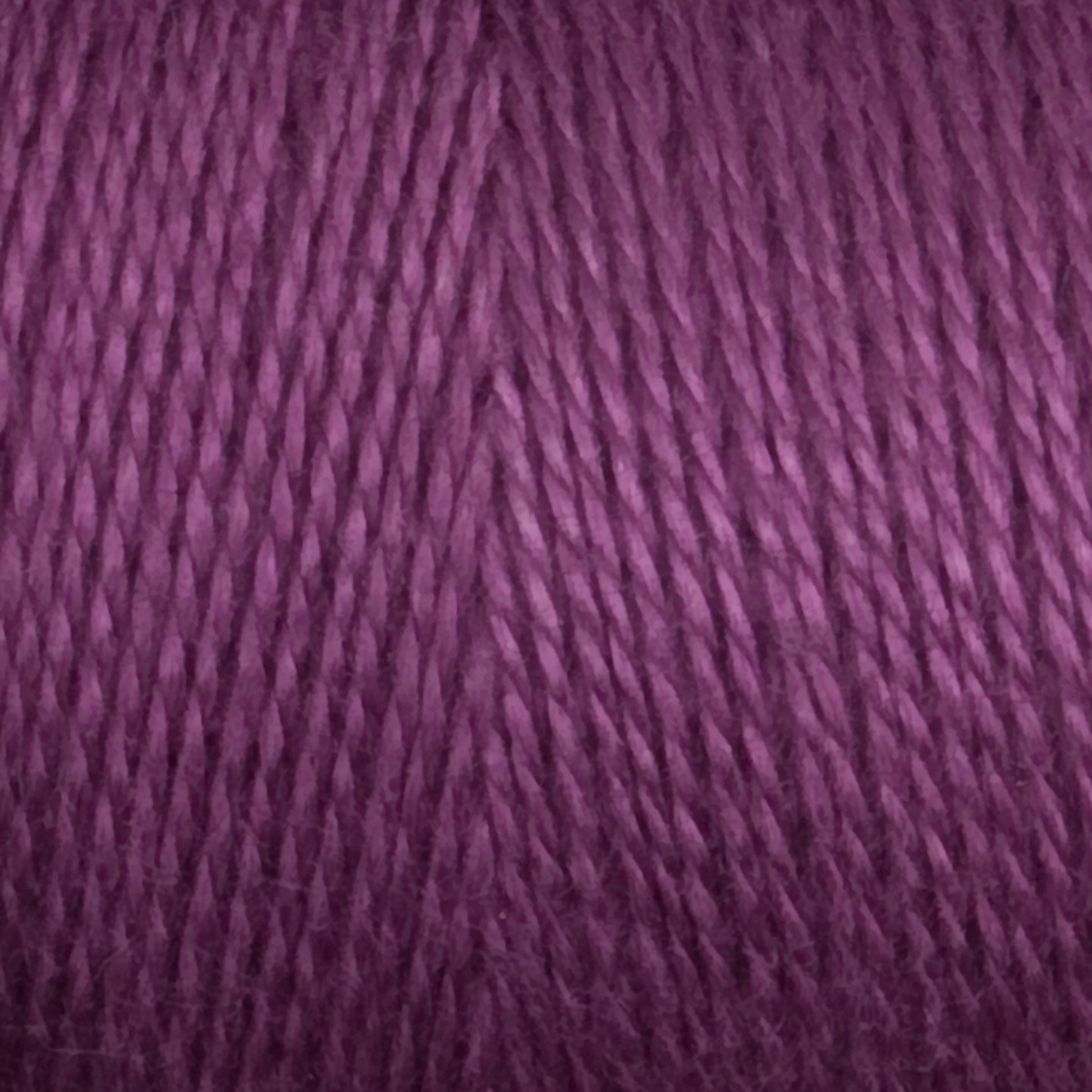 Close-up image of Maurice Brassard 8/2 Tencel Yarn | Mini Cone in violet purple, showcasing tightly twisted strands and a smooth, soft texture that's perfect for knitting accessories or weaving projects.