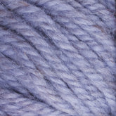 A close-up view of the Halcyon Yarn Classic Rug Wool by Caledonian Dye Works shows hand-dyed light purple strands tightly intertwined. The texture is soft and slightly fuzzy, with varied shades of purple creating a cozy and plush appearance.