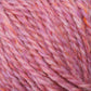 Close-up of a ball of Peace Fleece Yarn by Harrisville Designs, showcasing a vibrant blend of pink, orange, and purple fibers. The soft and fuzzy texture, crafted from a wool and mohair blend, reveals intricately intertwined threads. Its cozy appearance is perfect for worsted weight knitting or crocheting projects.
