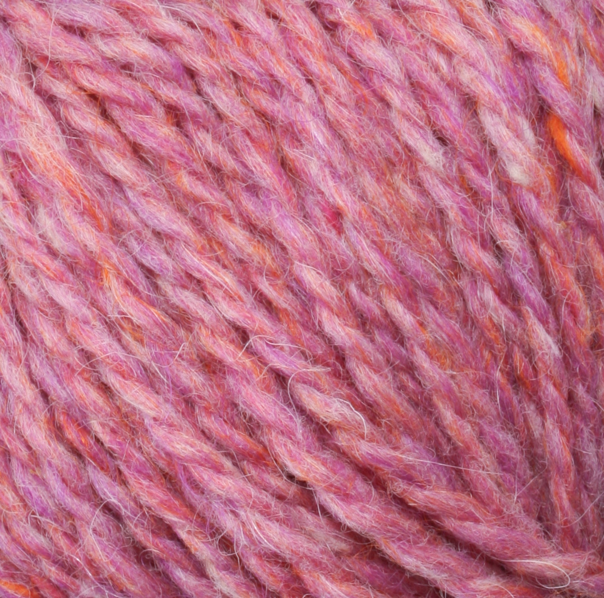 Close-up of a ball of Peace Fleece Yarn by Harrisville Designs, showcasing a vibrant blend of pink, orange, and purple fibers. The soft and fuzzy texture, crafted from a wool and mohair blend, reveals intricately intertwined threads. Its cozy appearance is perfect for worsted weight knitting or crocheting projects.
