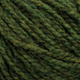 Close-up image of dark green Harrisville Designs Harrisville Shetland Yarn - Unwashed Cones, showcasing its texture and fibers. The yarn features a blend of shades from deep forest green to lighter, almost olive tones, giving it a rich and varied appearance. The texture looks soft and slightly fuzzy—perfect for Fair Isle knitting designs or lightweight blankets.