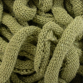 Close-up of a pile of Harrisville Potholder Loops - Traditional Size Mini Pack by Friendly Loom, tangled together. The texture of the cotton loops is clearly visible with a soft and slightly fuzzy appearance. The image highlights the intricate weaving pattern reminiscent of a traditional loom.