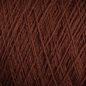 Close-up image of tightly wound dark brown JaggerSpun Maine Line 3/8 Yarn | Mini-cone by Jagger Brothers, Inc., highlighting the detailed texture and interwoven fibers. The yarn appears soft with a rich, earthy color, perfect for knitting or crocheting projects.