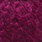 Close-up image of tightly curled, magenta-colored hair or fibers. The curls are densely packed, creating a textured and voluminous appearance. The vibrant magenta hue is consistent throughout, giving the material a rich, colorful look reminiscent of Caledonian Dye Works' Victorian Bouclé Mohair Yarn.