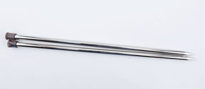 A pair of Accessories Unlimited Nova Platina Single Point Knitting Needles lies parallel to each other on a white background. The straight needles are shiny silver with pointed tips and have an end cap on each one, which appears to be made of wood or plastic.