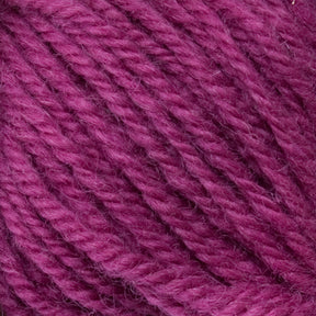 Close-up image of Halcyon Deco Rug Wool in a vibrant magenta hue. The 100% wool fibers from Caledonian Dye Works are neatly twisted together, showcasing a soft and smooth texture. This versatile yarn is ideal for various projects.