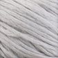 Close-up image of thick, soft white Cumulus Cotton yarn fibers by Juniper Moon Farm, loosely twisted together. The texture appears fluffy and smooth, with slight variations in shades of white and light gray throughout. This soft yarn from Knitting Fever / Euro Yarns, featuring durable chainette construction, looks cozy and suitable for knitting or crafting.