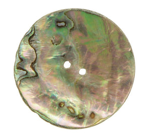 A round, iridescent Mexican Abalone Button by Skacel, featuring two central holes. The shell showcases a stunning blend of green, purple, and pink hues with natural patterns and textures. Ideal for infusing an elegant touch into completed sweaters.