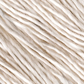 Close-up of Henry's Attic Soft Twist Natural Silk Yarn in shades of white and light beige, shown in parallel rows. The natural fibers appear soft, with slight irregularities in thickness and color, giving a natural and organic appearance.