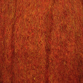 A close-up of a textured, thick fabric in a rich, burnt orange color. The fuzzy interwoven threads of Harrisville Dyed & Carded Wool Fiber from Harrisville Designs create a warm and dense appearance. The combination of red and orange shades gives it a vibrant yet earthy look, reminiscent of heathered colors.