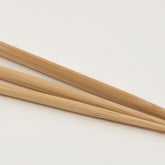 Three Jumbo Bamboo Blunt Needles from Accessories Unlimited are laid out against a plain white background. Each needle has a long, slender shape with a large, elongated eye at one end and a pointed tip at the other. The needles are slightly different in length.