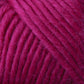 Close-up image of magenta-colored Brown Sheep Lamb's Pride Worsted Yarn, showing the soft, thick strands tightly wound together. The texture appears fluffy, highlighting the individual fibers making up the yarn—ideal for felting projects.