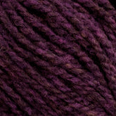 Close-up view of thick, purple Harrisville Shetland Yarn - Unwashed Cones from Harrisville Designs, with subtle variations in color showcasing the texture and twists of the fibers, perfect for intricate Fair Isle knitting designs.