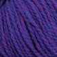 A close-up image of the Harrisville Designs Shetland Yarn - Unwashed Cones reveals thick, purple intertwined strands of fiber, blending shades of purple and blue with hints of red. The texture appears soft and suitable for lightweight blankets or Fair Isle knitting designs.