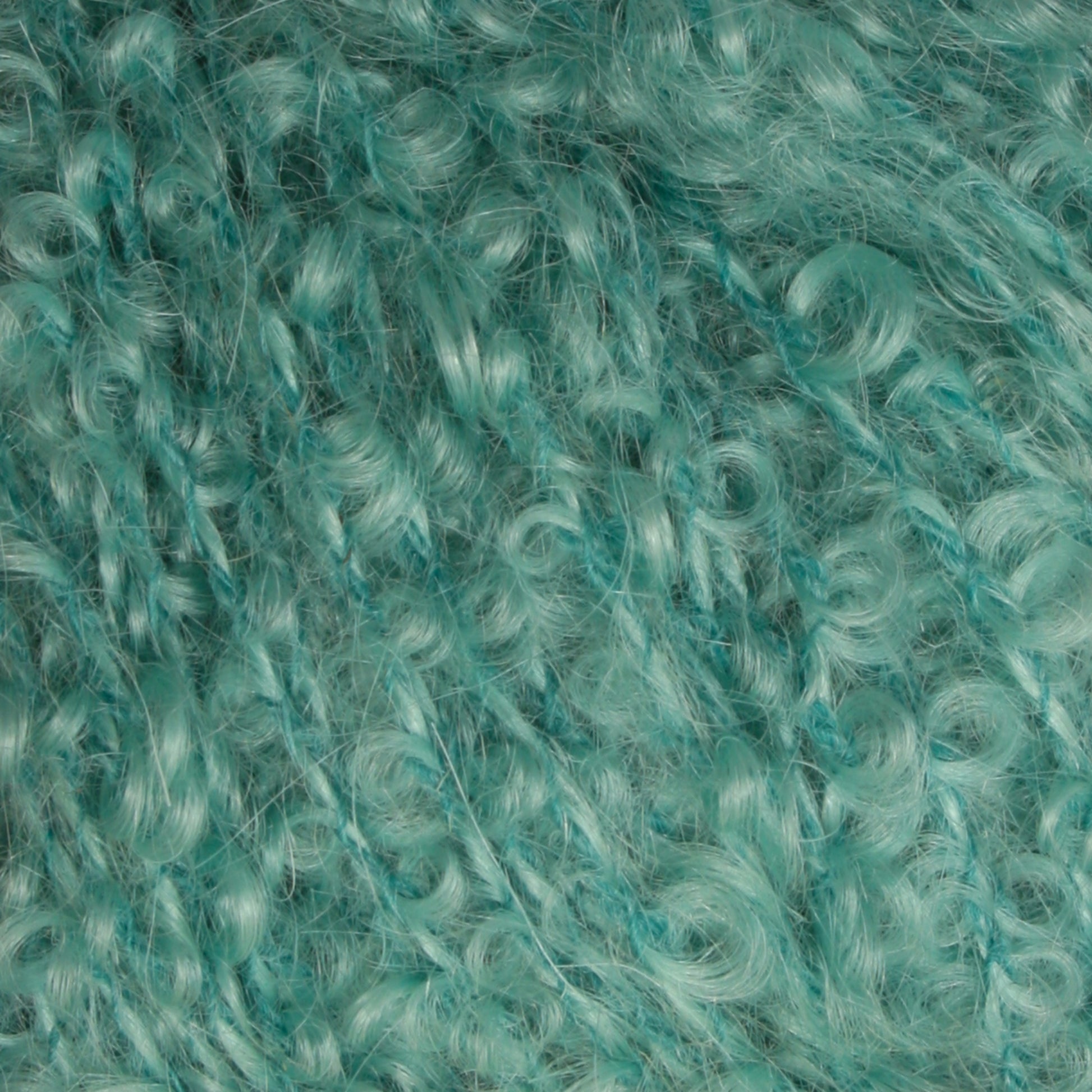 Close-up of turquoise Victorian Bouclé Mohair Yarn from Caledonian Dye Works, showcasing its soft and fluffy texture. The curls are densely packed, creating a tactile and visually intricate pattern that highlights the yarn's thickness and color consistency.