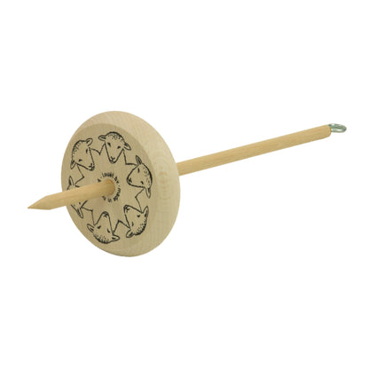 The Louët Low Whorl Drop Spindle by Louët Inc. features a round disk adorned with decorative sheep patterns. This wooden spindle includes a long, pointed shaft with a hook at one end for spinning fibers into yarn. The light-colored disk displays the sheep motifs arranged in a circular pattern.