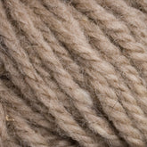 Close-up image of Halcyon Yarn Classic Rug Wool | Skein by Caledonian Dye Works. The yarn is a natural, undyed beige color with a soft, slightly fuzzy texture. The fibers are thick and twisted together, showing a detailed view of the strands and their intertwined structure—perfect for weavers seeking high-quality rug wool.