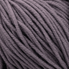 Close-up image of a mass of thick, twisted threads of Plymouth Select Worsted Merino Superwash yarn in a muted purple color, showcasing the texture and slight fuzziness of the merino fibers by Plymouth Yarn Co.