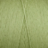 Here's a close-up image of Maurice Brassard's Medium Cotton 16/8 Mop Yarn in a light green shade, neatly wound into a skein. The sturdy cotton yarn strands run parallel and are tightly aligned, showcasing a soft and smooth texture perfect for knitting or crocheting projects.