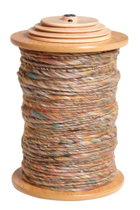 An Ashford Bobbin for Country Spinner by Ashford Handicrafts Limited is wrapped with multicolored yarn, showcasing hues of brown, orange, blue, and green. The variegated appearance of the yarn is neatly displayed as the spool stands upright with tightly wound threads.