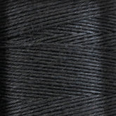 A close-up view of tightly wound black thread or yarn from the 16/5 Linen Rug Lacing (Black) | Mini-cone by Stuart C. Hurlbert & Co., showcasing the texture and detail of each strand. The smoothness is evident, with fibers appearing neatly aligned, hinting at the strength that makes them ideal for the heaviest rugs.