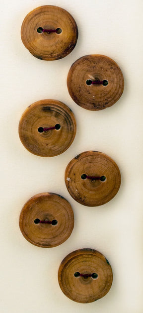 Product Description: The Six Buttons by Favour Valley Woodworking are wooden buttons arranged vertically in two columns, each with two holes in the center. Crafted from local wood, these buttons showcase natural grain patterns and a light brown hue, resting against a beige background.