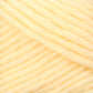 Close-up of Brown Sheep's Lamb's Pride Bulky Yarn, a thick and soft yellow yarn. The yarn is densely packed, showcasing its texture and fibers. Often used by knitters and crocheters, the strands are neatly wound and parallel to each other, highlighting the uniformity and plush quality of the material.