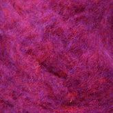 Close-up image of a textured surface, showcasing a mix of heathered colors in various shades of purple and red. The fibers interweave to create a soft, fuzzy appearance, likely Harrisville Dyed & Carded Wool Fiber from Harrisville Designs.