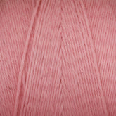 A close-up image of Maurice Brassard Cotton 8/8 Carpet Warp in a ball. The texture of the unmercerized cotton is visible, showing the individual strands twisted together. The color is a soft, muted pink with uniform thickness, perfect for knitting and crochet projects.