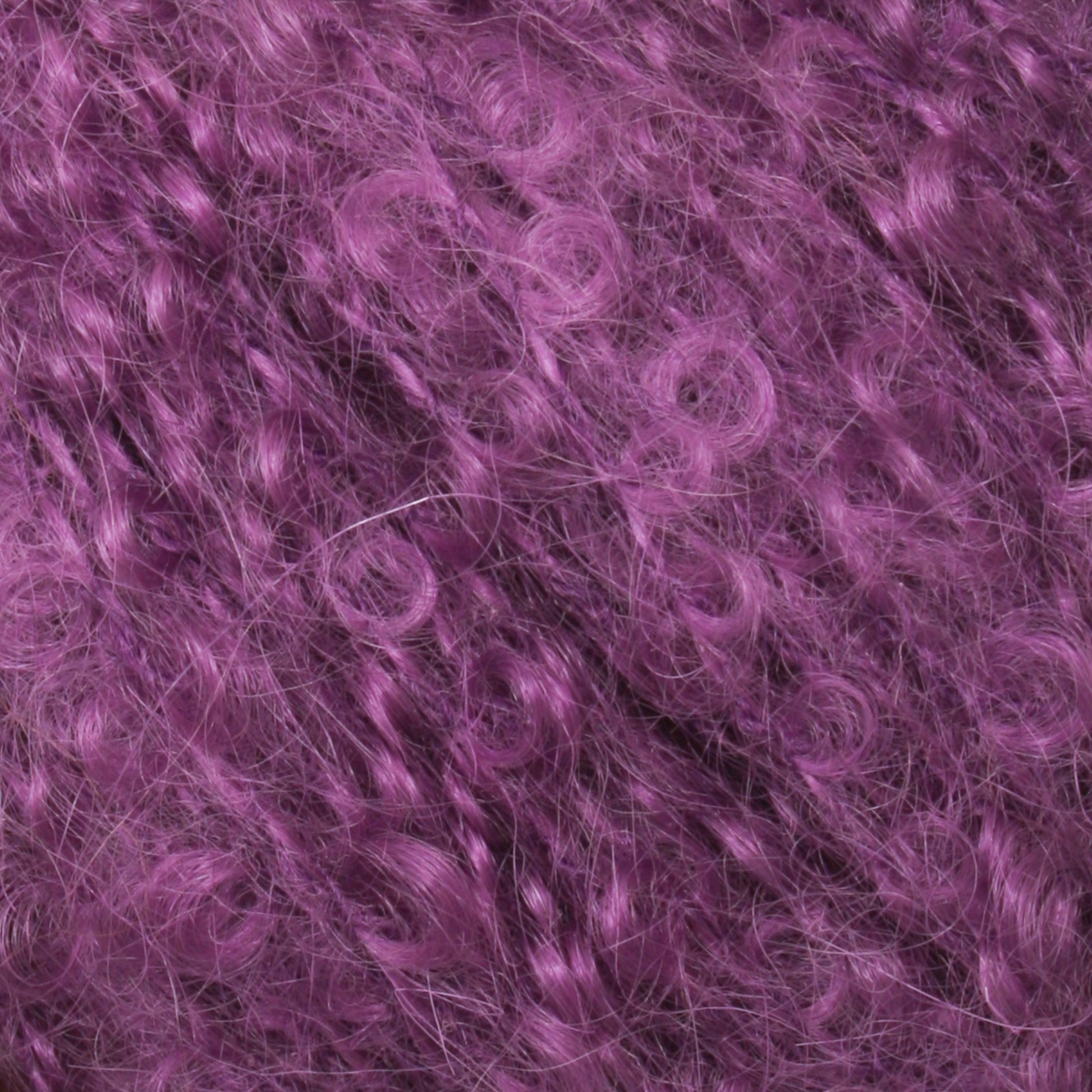 Close-up of curly purple hair, showcasing the texture and vibrant color. The image highlights the detailed twists and loops of the curls, giving a sense of volume and richness reminiscent of Victorian Bouclé Mohair Yarn from Caledonian Dye Works.