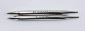 Two Nova Platina Interchangeable Knitting Needles by Accessories Unlimited, each with a 4.5" tip and "US 11/8.0 mm" engraved on them, crafted from hollow brass pipes, are placed parallel to each other on a plain white background.