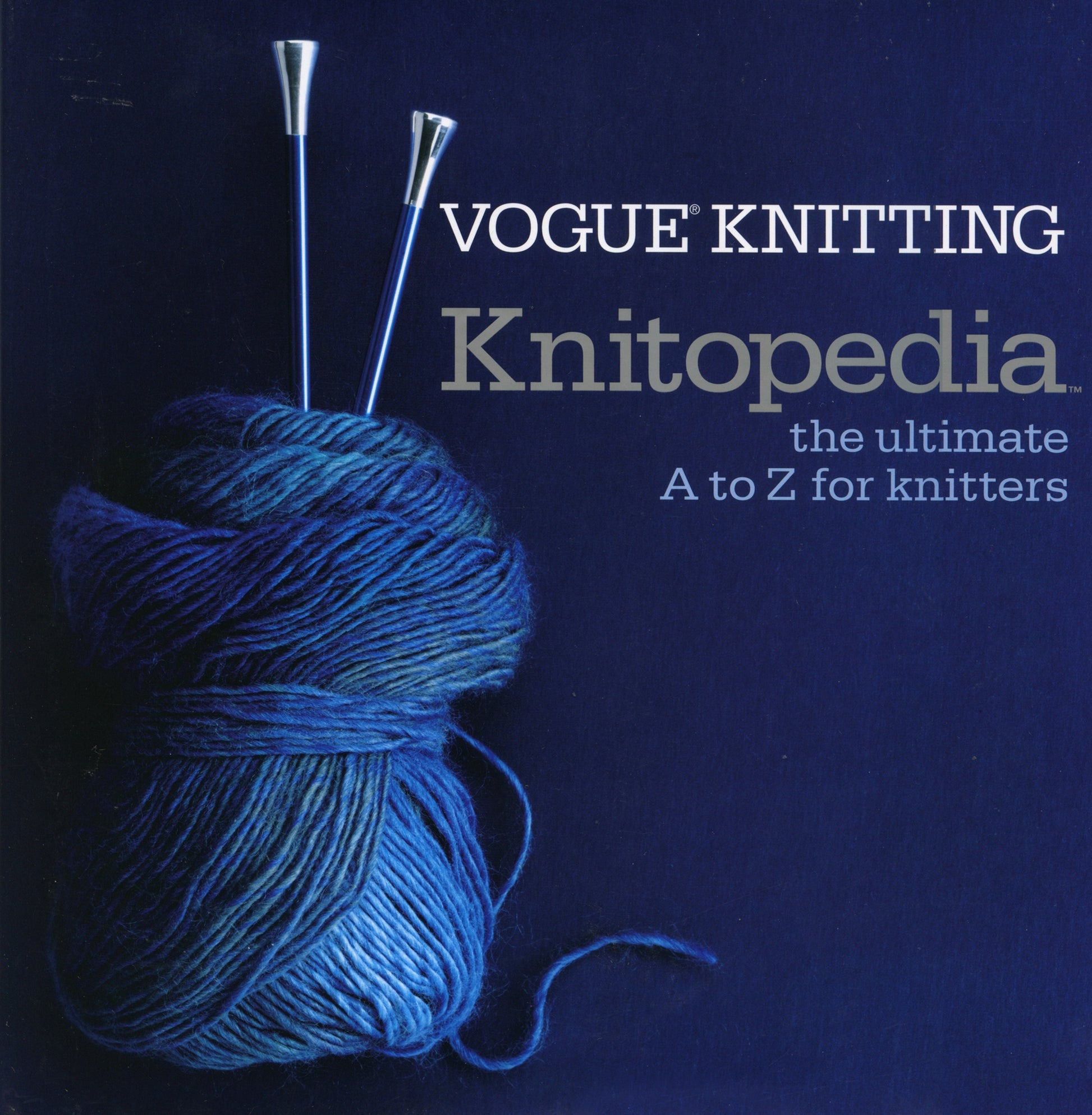 A book cover from Soho Publishing, titled "Vogue Knitting Knitopedia: The Ultimate A to Z for Knitters," features blue yarn wrapped around two knitting needles against a dark blue background. The title appears at the top right, with the yarn and needles positioned on the left, embodying a comprehensive knitting encyclopedia.