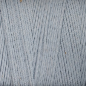 A close-up image of **Maurice Brassard's Medium Cotton 16/8 Mop Yarn**, tightly wound and showcasing a smooth, even texture. The yarn strands, made from sturdy cotton, run vertically with some interwoven diagonally, highlighting the fine quality perfect for weaving. Small specks are visible, adding subtle detail.