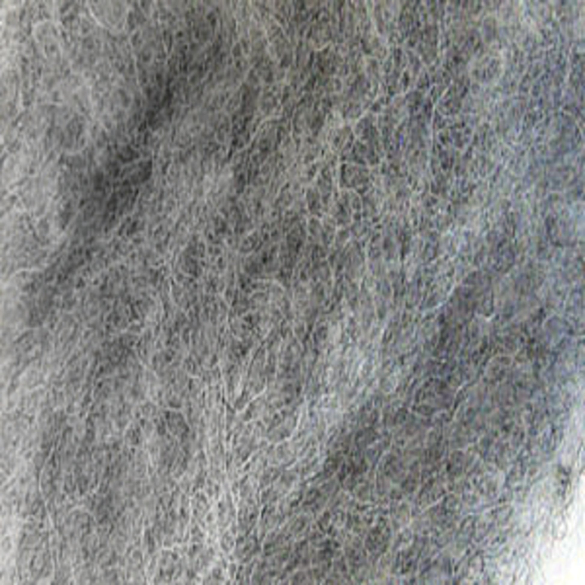 A close-up image of a gray fuzzy textile material. The image shows the dense and intricate fibers, creating a soft and woolly texture reminiscent of Harrisville Dyed & Carded Wool Fiber by Harrisville Designs. The fibers vary slightly in shades of gray, giving a heathered, mottled appearance.