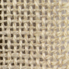 Close-up image of a piece of beige 60" Rug Backing by Dorr Fabrics Inc, featuring a simple grid-like pattern created by interlacing horizontal and vertical threads. The texture appears coarse, emphasizing the individual fibers and natural look of the material.