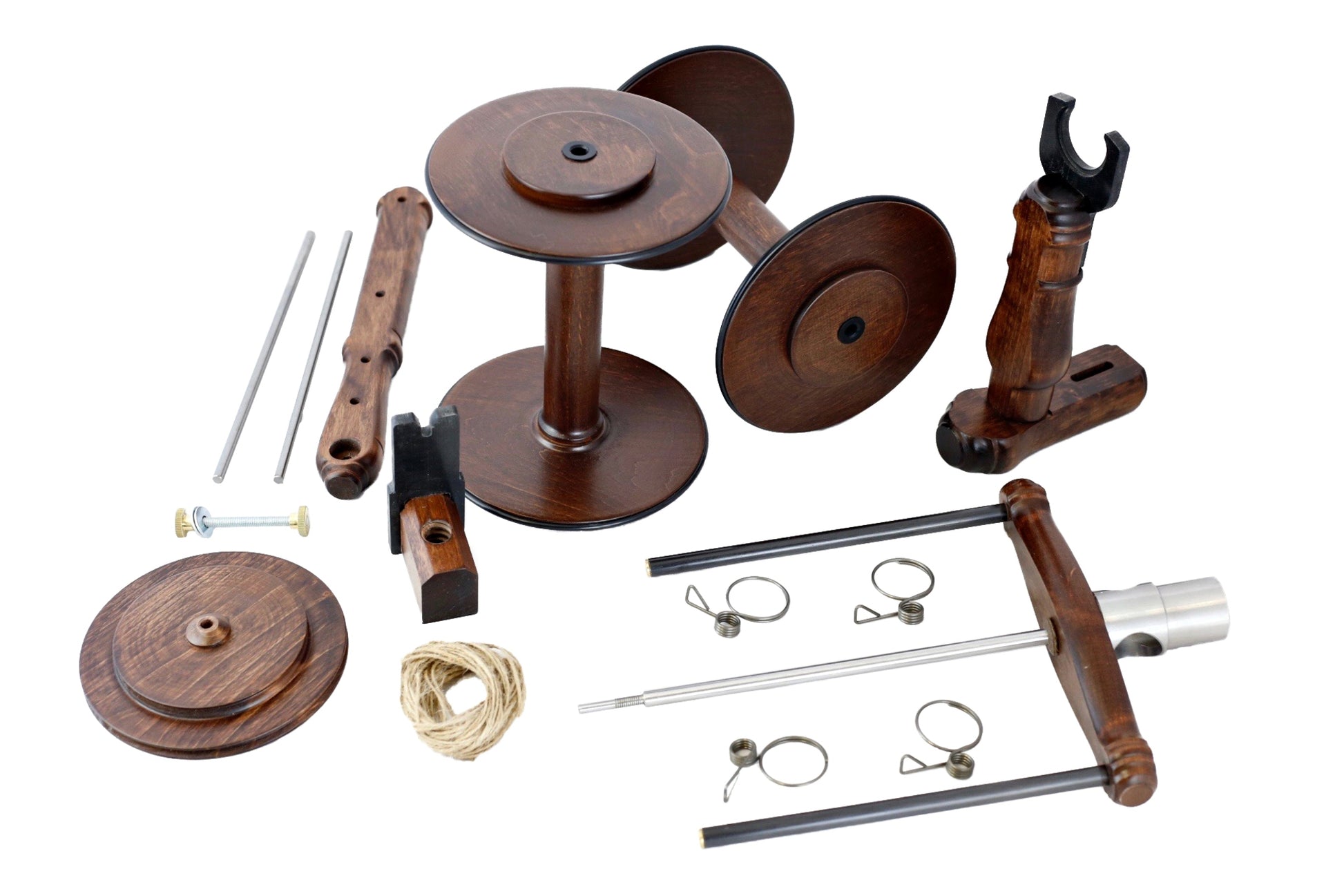 A disassembled Kromski Minstrel Wheel Great Flyer Set from Kromski North America with various components laid out, including two round bases, a central spindle, pegs, metal rods, small clamps, a roll of twine, and an adjustable tensioner. The parts are arranged neatly on a white background.