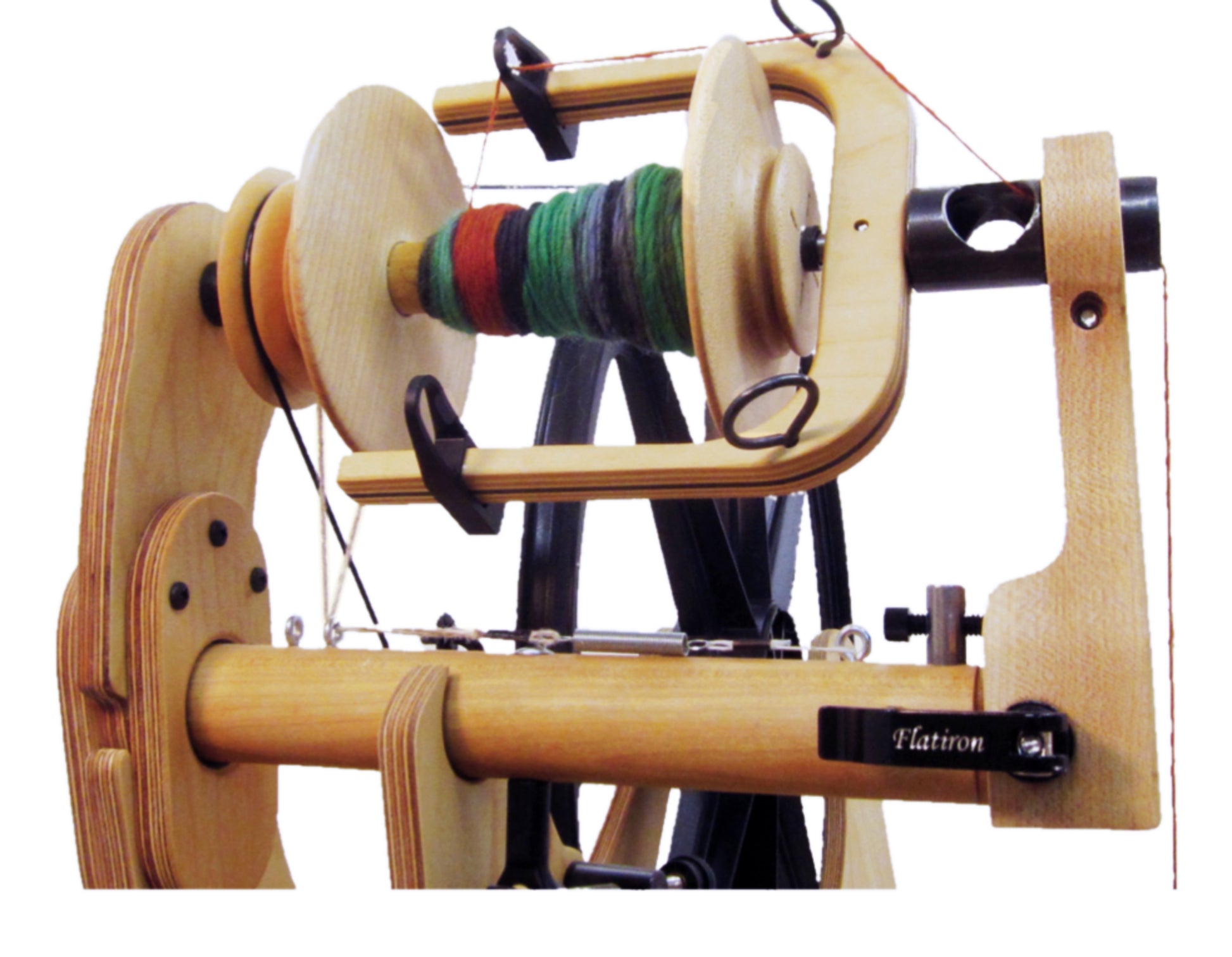 A wooden Schacht Bulky Plyer Flyer Package with colorful yarn wound around the bobbin. The wheel has various mechanical parts, including a large circular drive wheel and guiding hooks, and it features the brand name "Schacht Spindle Co." on one end.