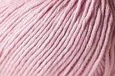 Close-up image of Jo Sharp Soho Summer DK Cotton yarn by Kingfisher Yarn & Fibre. The soft, pale pink cotton showcases tightly coiled strands with visible twists and folds, creating a plush, cozy appearance. This lightweight yarn appears thick and suitable for knitting or crocheting projects.