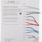 The Halcyon Yarn "Happy Feet Sock Sample Card" offers a collection of 15 vibrant yarn strands, featuring a luxurious Merino and Nylon blend by Plymouth Yarn. Each strand is meticulously labeled with individual color codes (0001 to 0015) and arranged in a vertical column, displaying an array of hues from white to darker shades.