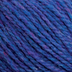 Close-up image of Harrisville Highland - Cones multicolored yarn by Harrisville Designs, featuring various shades of blue and purple with occasional hints of pink. The texture appears soft and slightly fuzzy, showcasing the individual strands twisted together tightly, characteristic of Harrisville Highland's renowned blends.