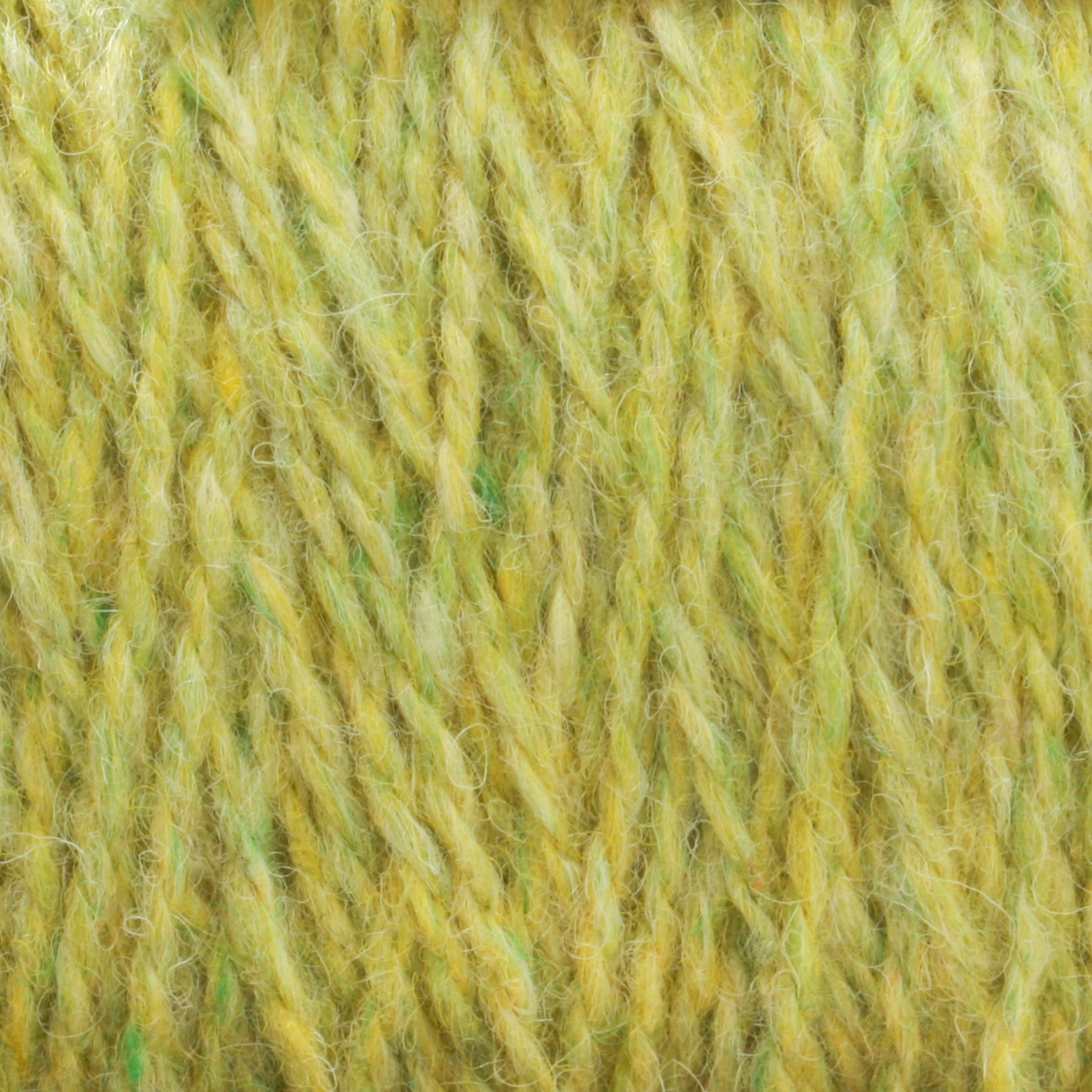 Close-up of Harrisville Designs' Harrisville Shetland Yarn - Unwashed Cones in a soft, yellowish-green hue. The twisted strands reveal shades of yellow, green, and hints of white, creating a textured and slightly fuzzy appearance. Ideal for Fair Isle knitting projects and lightweight blankets, the image showcases the detailed fibers and consistent thickness.