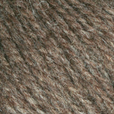 Close-up of Bartlettyarns Maine Wool Yarn, displaying tightly woven fibers with heathered colors of light and dark brown strands. The material appears coarse with visible individual threads, creating a dense and earthy pattern that echoes the rustic charm of this Bartlettyarns product.